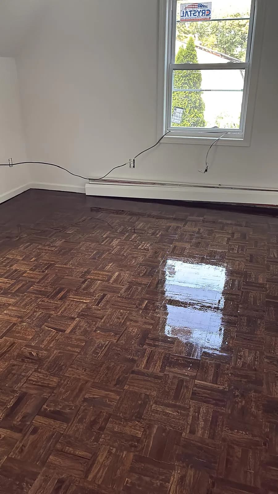 Vintage parquet wood floor refinished to a glossy dark finish