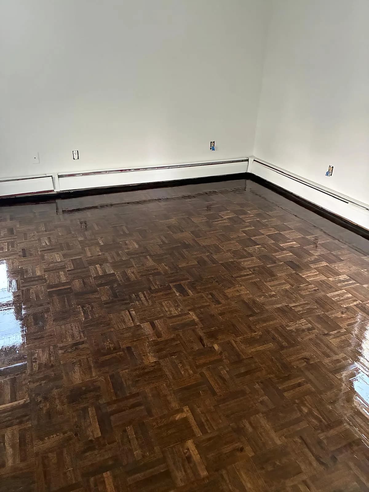 Dark parquet floor refinished to a high gloss